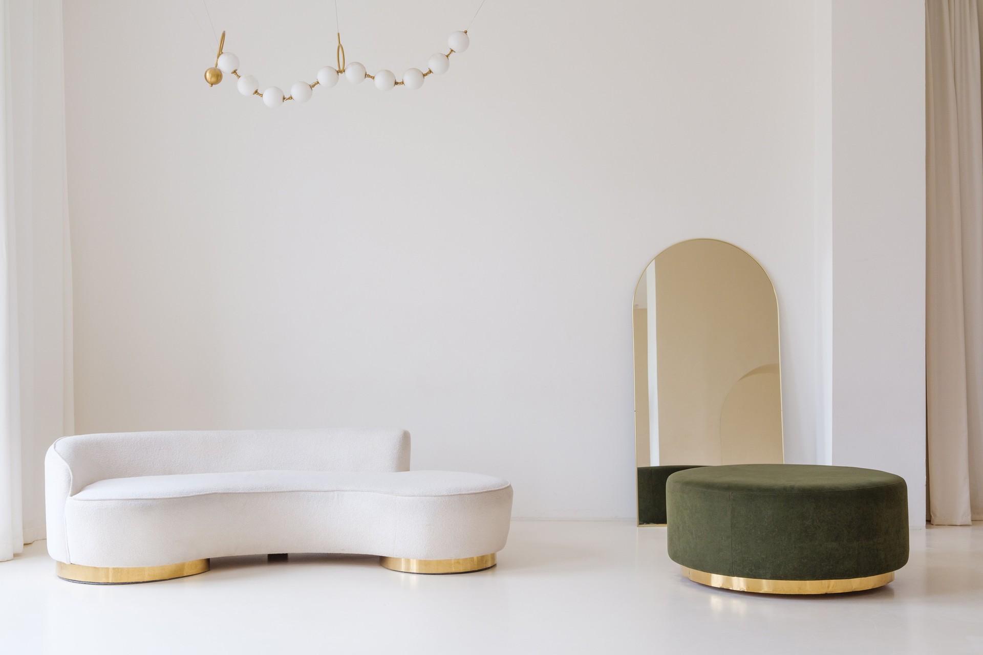 Modern Minimalist Interior with Green Velvet Ottoman and Gold Accents
