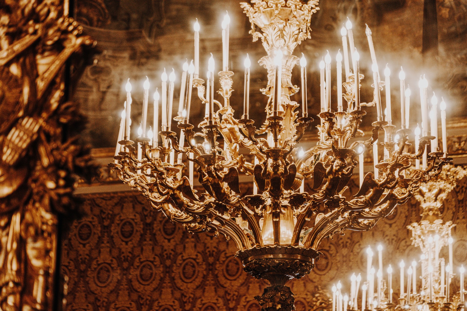 Elegant Golden Chandelier Illuminating an Opulent Vintage Room