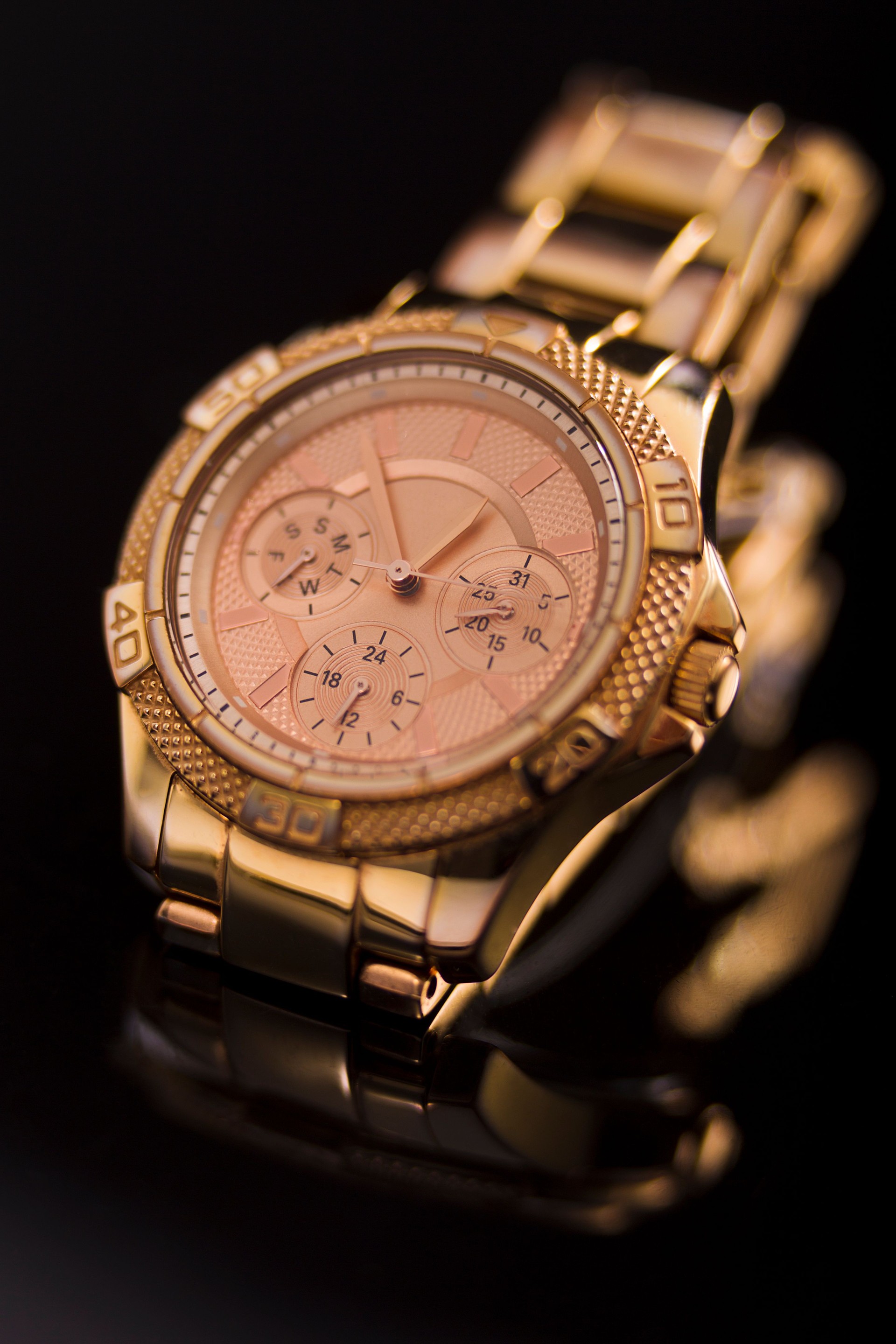 Gold watch on a plastic background