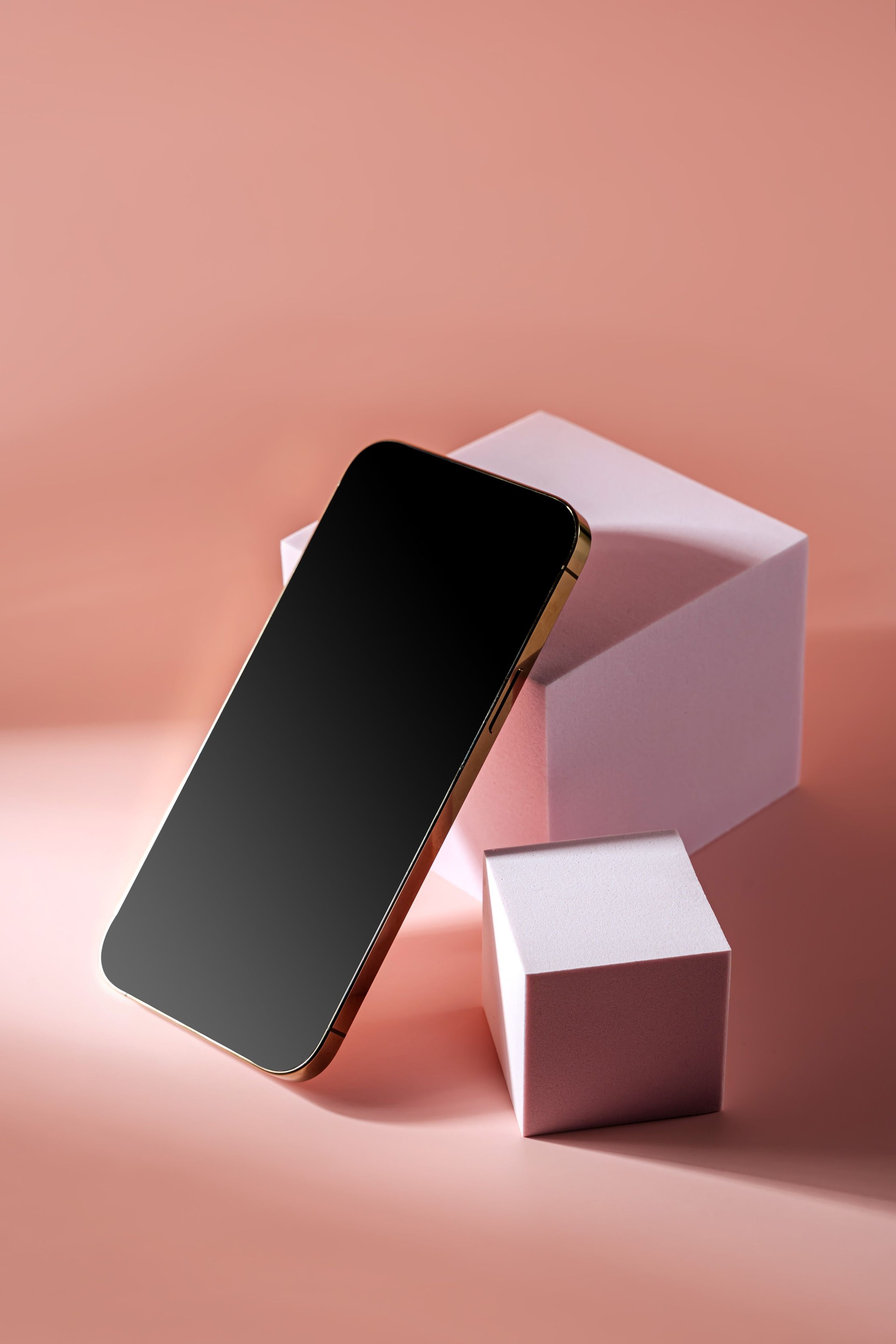 Smartphone with blank black screen. Mobile phone on cube podium.  Pedestal mockup space for display of app.