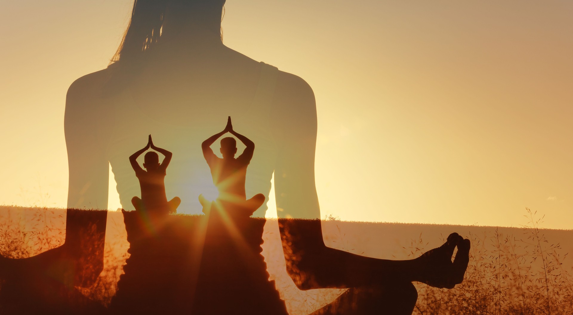A double-exposure image shows two yoga silhouettes meditating in a field at sunrise. Warm light creates calm inner peace balance, and mindfulness, blending nature with peaceful fitness practice.